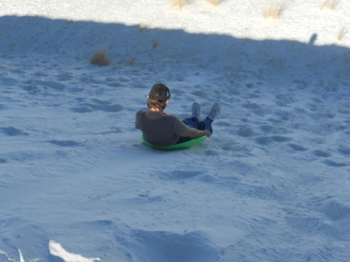 MG sledding down one of the dunes